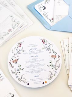 the wedding stationery is laid out on the table