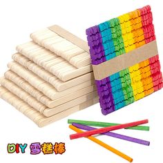 a stack of wooden pegs next to some colored sticks