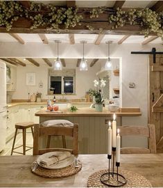 an open kitchen and dining area with candles on the table