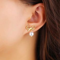 Introducing our Bow Pearl Earrings, a must-have accessory for any fashion-forward individual. With a super cute bow design and luxurious pearls, these earrings add a touch of girly charm to any outfit. Embrace the latest trend with these exclusive earrings. Made to last! Non Tarnish and Water Resistant, Hypoallergenic .78" Long 18K Gold Plated over 316L Stainless Steel base Trendy Pearl Charm Earrings For Party, Trendy Bow Drop Earrings, Cute Pearl Drop Earrings For Gift, Cute Pearl Drop Earrings As Gift, Trendy Pearl Charm Earrings For Gift, Trendy Pearl Earrings With Pearl Charm For Party, Trendy Party Pearl Earrings With Charm, Pearl Jewelry With Bow Detail, Exclusive Earrings