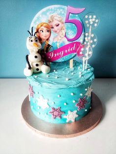 a frozen princess birthday cake with the number five on it