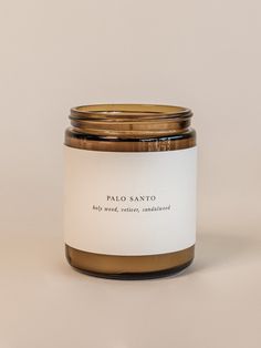 a glass jar with a label on it sitting in front of a white wall and floor