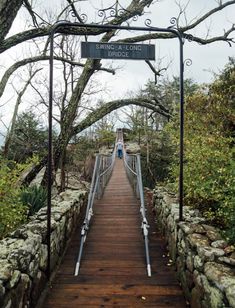 a wooden bridge that has a sign on it