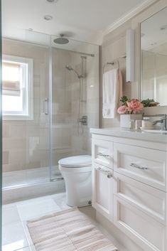 a bathroom with a sink, toilet and shower in it's own area is shown