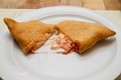 two pieces of pizza sitting on top of a white plate