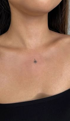 a woman's chest with a small star tattoo on her left side ribcage