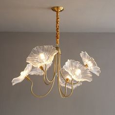 a chandelier hanging from the ceiling with flowers on it