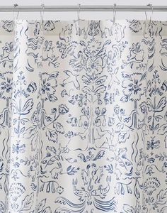 a blue and white shower curtain with an intricate design