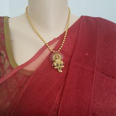 "Handmade Indian Jewelry item * Stunning Hand made Traditional jewelry set. * Necklace Set is a combo of Necklace & Stud Earrings * Necklace is adjustable with adjustable back chain/ Dori/ Cord * Main Necklace Length: 18\", Pendant length H : 2\" and W 1.25\" * Earring Length: 1\", Earring Width: 0.6\" * Packed in a box, Ideal For GiftingOn Request, We Can Add A Custom Message For Your Loved One (At No Additional Cost) :) * Gold Color is Matte gold tone, which has a copper hue as opposed to Festive Beaded Pendant Jewelry, Spiritual Gold Jewelry Sets For Festivals, Temple Jewelry Necklace With Beaded Chain For Festive Occasions, Festive Temple Jewelry Necklace With Beaded Chain, Festive Pendant Jewelry With Beaded Chain, Festive Gold Jewelry Set With Detachable Pendant, Temple Jewelry Sets With Latkans In Metal, Metal Temple Jewelry Sets With Latkans, Brass Temple Necklace With Latkans For Puja