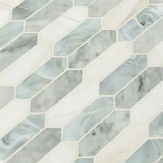 a white and grey marble mosaic tile with wavy lines in the center, on top of each other