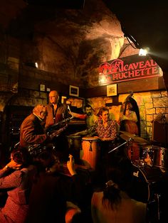 some people are playing instruments in a bar