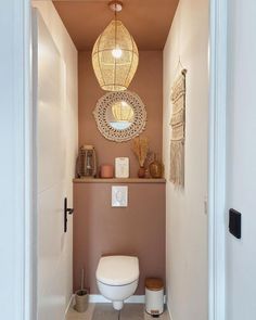 a white toilet sitting inside of a bathroom next to a doorway