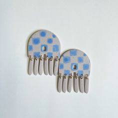 two white and blue combs sitting on top of each other next to each other