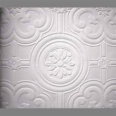 a white ceiling tile with decorative designs on the top and bottom part, in an ornate pattern