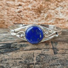 Welcome to my shop, Elegant Round Lapis Lazuli Adjustable Bangle in Sterling Silver - Handcrafted Artisan Bracelet with Deep Blue Gemstone, Lapis Lazuli Bangle. Metal : 925 Sterling Silver  Gemstone : Lapis Lazuli Thanks for visiting my shop. Natural Lapis Lazuli Bracelets, Adjustable Gemstone Bangle, Sapphire Lapis Lazuli Bracelets As Gift, Adjustable Round Bangle With Gemstone, Adjustable Round Gemstone Bangle, Handmade Adjustable Sapphire Jewelry, Handmade Blue Bangle Jewelry, Bohemian Lapis Lazuli Gemstone Bracelets, Handmade Adjustable Lapis Lazuli Bracelets