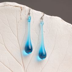 "These Light blue long teardrop dangle earrings are made of glass in lampwork technique. The stainless steel hooks are hypoallergenic. They will not tarnish, fade, or discolor with time. These unique and beautiful earrings are like water drops frozen in glass! They are simple and elegant, very lightweight and comfortable to wear, perfect for everyday wear and for special occasions. You will definitely receive lots of compliments on your new earrings, everybody loves them, and you'll love them to Blue Long Drop Teardrop Earrings With Ear Wire, Modern Blue Long Drop Jewelry, Modern Blue Teardrop Jewelry, Modern Blue Long Drop Earrings, Blue Teardrop Drop Earrings, Blue Teardrop Earrings With Ear Wire, Blue Drop Earrings Hypoallergenic, Blue Long Drop Teardrop Earrings Gift, Elegant Blue Hypoallergenic Teardrop Earrings