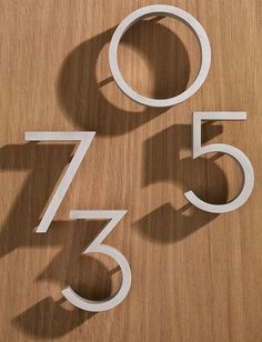 the numbers are cut out of wood and placed on top of each other