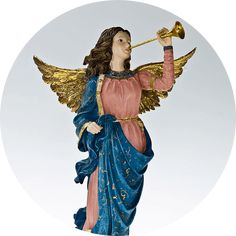 an angel figurine holding a trumpet in its right hand and wearing a blue dress