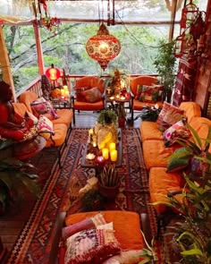 a living room filled with lots of furniture and candles on top of each couches