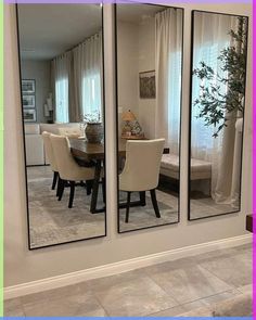 the reflection of a dining room table and chairs in a large mirror doored wall