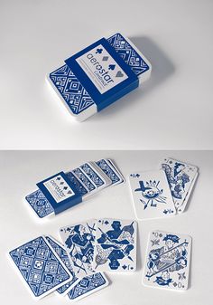 several playing cards are laying on top of each other in blue and white designs,