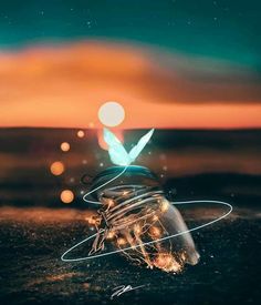 a glass jar sitting on top of a sandy beach under a colorful sky at night