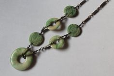 -Antique Chinese Enamel Carved Jadeite & Disk Necklace -Total length: 16 in -Biggest disk size: 25 mm -Small disk size: 17 mm -Carved jadeite:about 15 mm ~ 16 mm -Total weight: 15.7 g -It's uneven, one side have two carved jadeite and a disk, another size have one jadeite and a disk Green Medallion Necklace For Formal Occasions, Vintage Jade Round Pendant Jewelry, Round Jade Collectible Jewelry, Collectible Round Jade Jewelry, Handmade Art Deco Round Necklace, Vintage Jade Necklace For Formal Occasions, Vintage Green Jade Necklaces, Vintage Oval Jade Necklace, Vintage Green Round Pendant Jewelry