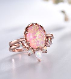 Opal Wedding Ring Set Oval Pink Fire Opal Engagement Ring Vintage Sterling Silver Ring Opal Matching Band Promise Ring Bridal Set Unique wedding set,perfect as engagement/wedding ring, birthday or anniversary gift, etc. Engagement Ring ❀gemstone is 8x10mm oval cut lab-created pink fire opal❀ ❀925 Sterling Silver,Rose/White/Yellow Gold Plated❀ Wedding Band ❀2.5mm+1.5mm Round cut and 3x5mm Pear cut lab-created white fire opal❀ ❀Curve height 4mm,curve width 9mm. ❀925 Sterling Silver,Rose/White/Yell Dark Opal Engagement Ring, Antique Opal Ring Vintage, Gold Bridal Sets With Round Gemstone, Gold Bridal Sets With Gemstones, Rose Gold Wedding Ring With Oval Cabochon, Rose Gold Gemstone Ring For Wedding, Oval Silver Bridal Sets, Heirloom Oval Cabochon Jewelry For Wedding, White Gold Oval Rings For Marriage