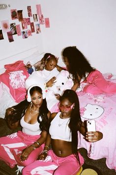 four girls in pink pants and white shirts on a bed