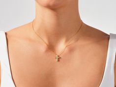 Embrace the power of faith in a minimalist way with the Small Cross Necklace. This understated piece features a delicate cross pendant, perfect for everyday wear and layering. Crafted from gleaming precious metal, the cross serves as a constant reminder of your faith, even when close to your heart. The small size ensures this necklace offers a touch of faith without overwhelming your outfit. It's perfect for those who prefer minimalist jewelry or for everyday wear. FEATURES• Made to Order• Gold Yellow Gold Crucifix Necklace With Delicate Chain, 14k Gold Cross Necklace With Delicate Chain, Dainty Yellow Gold Crucifix Cross Necklace, Dainty Yellow Gold Crucifix Necklace, Yellow Gold Cross Necklace With Delicate Chain, Yellow Gold Crucifix Cross Necklace, Yellow Gold Fine Jewelry Cross Pendant Necklace, Small Cross Necklace, Signet Ring Men