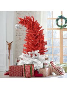 a red and white christmas tree with presents under it