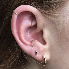 a woman with three piercings on her ear