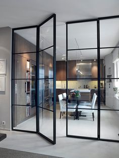 an open glass door leading to a dining room