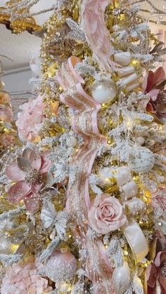 a christmas tree decorated with pink and gold ornaments