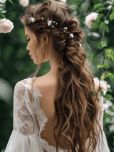 a woman with long hair and flowers in her hair, wearing a white wedding dress