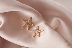 "Looking for a meaningful and spiritual jewelry gift, that is equally stunning? Our \"Sea Star\" starfish earrings are the perfect spiritual yet dazzling gift for your best friend. At a glance, they appear to be inspired by the famous sea creatures, but if you look under the surface there is much more to these gold starfish stud earrings. Starfish represents divine love, protection, and regeneration. These beautiful sea star stud earrings in gold feature tiny crystal zirconia diamonds glimmering Ocean-inspired Jewelry With Star Charm As Gift, Ocean-inspired Star Charm Jewelry Gift, Starfish Shaped Jewelry With Star Charm As Gift, Elegant Handmade Starfish Earrings, Minimalist Starfish Jewelry Gift, Elegant Starfish Charm Earrings As Gift, Elegant Starfish Charm Earrings For Gift, Elegant Starfish-shaped Nickel-free Jewelry, Elegant Nickel-free Starfish Jewelry