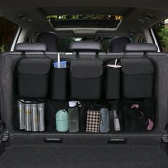 the back end of a car with several items in it's trunk and rear seats