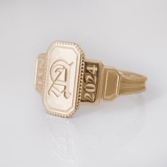 This vintage style signet ring is inspired the Art Deco style and is a perfect vintage-style graduation ring for high school or college grads! A truly stand-out ring to last forever - and makes a perfect gift!  This ring can be customized with any letter or word (provided it fits) and is made in solid gold. This ring can be made for men or women and in your preferred size or color of gold. A phrase or letter may be written on the inside, too! Please note that up to 4 characters are available for Vintage Gold Signet Ring, Simple Class Rings High School, State Champ Ring, Meredith College Ring, Class Rings High School Reeds Jewelers, Class Rings High School Vintage, Baylor University Class Ring, Class Ring Alternative, Senior Ring Ideas