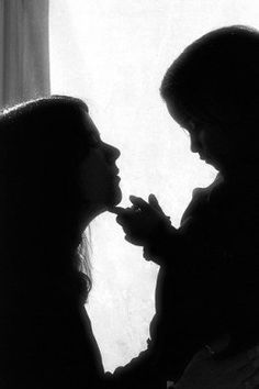 two women standing next to each other in front of a window with sunlight streaming through them