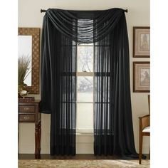 black sheer curtains hanging in front of a window