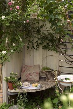 an outdoor table and bench with flowers on it