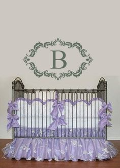 a crib with purple ruffles and bows on it