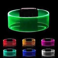 a cell phone sitting on top of a neon colored wristband with multiple colors around it