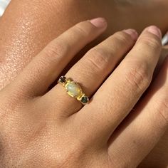 Choose between these gorgeous polished Ethiopian opal rings with amazing sparkles set in sterling silver and then gold plated. The ring has a little different faceted tourmaline on each side of the main stone. Choose between: Blue and yellow- N 1/2 (UK/AU size ring) 6 3/4 (US size) Green and brown- L 1/2 (UK/AU size ring) 5 7/8 (US size) Blue and pink- N 1/2 (UK/AU size ring) 6 3/4 (US size) Pink and brown- M 1/2 (UK/AU size ring) 6 1/4 (US size) This ring would make the most perfect bridesmaid' Gold Opal Ring With Birthstone, Gold Opal Birthstone Ring, Gold Ethiopian Opal Birthstone Ring, Gold Opal Multi-stone Ring, Yellow Gold Moonstone Ring With Ethiopian Opal, Yellow Gold Ring With Ethiopian Opal And Birthstone, Yellow Gold Ethiopian Opal Ring With Birthstone, Yellow Gold Ethiopian Opal Birthstone Ring, Gold Opal Ring In Sterling Silver