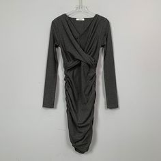 This dress features a V-neckline, pleating to create a shaping effect, and concealment of the tummy. The skirting is designed to fit closely to the body, adding a touch of elegance and sophistication to the overall look. The dress is a perfect choice for any occasion, whether it's a formal event or a night out on the town. The pleating also adds a touch of flexibility to the dress, allowing it to fit comfortably and move easilySeason: Spring, Summer, AutumnSize: FColor: Dark Grey, Black, Burgund Pleated Skirt Dress, Dress Shapes, Mid Length Dresses, Formal Event, Pleated Skirt, Dark Gray, Dress Skirt, Dark Grey, Night Out