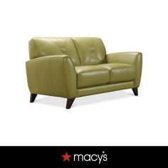 a green leather couch sitting on top of a white floor next to a red star