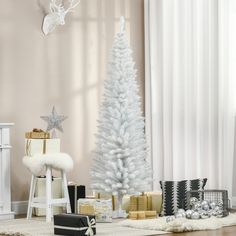 a white christmas tree surrounded by presents