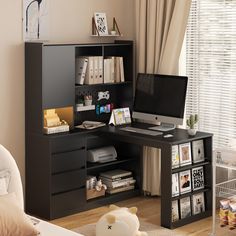 a computer desk with a monitor and keyboard on it in front of a book shelf