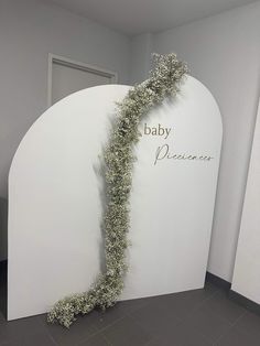 a white arch that has some plants growing out of it