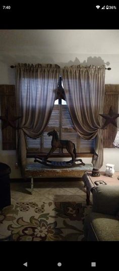 a living room filled with furniture and curtains